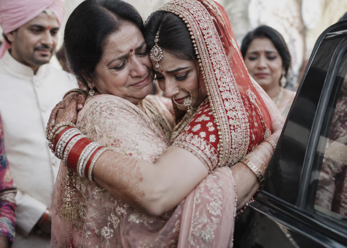 Bride embracing her mother during the vidai